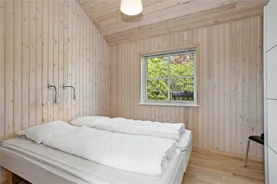 a room with a white couch in a room with a window at BL704-Blokhus-Soren-Petersvej-7 in Blokhus