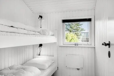 a room with two bunk beds and a window at LK2141-Lokken-Kristavej-15 in Løkken