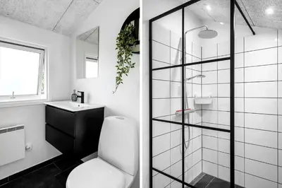 a bathroom with a toilet and a glass shower at LK2141-Lokken-Kristavej-15 in Løkken