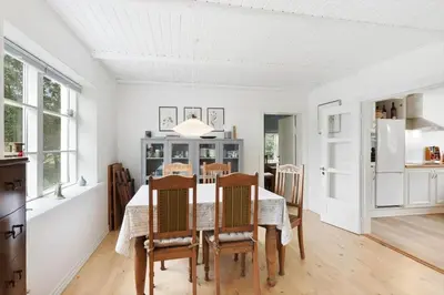 a kitchen and dining room with a table and chairs at BL367-Pandrup-Rodhus-Kirkevej-5 in Pandrup