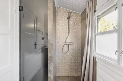 a shower in a bathroom with a shower curtain at BL1363-Blokhus-Fiskene-7 in Blokhus