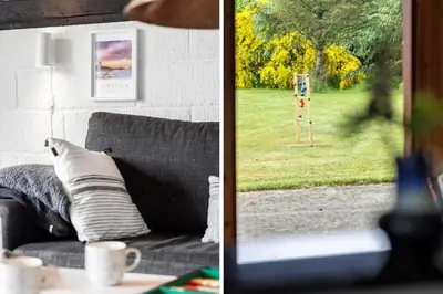 a living room with a couch and a view of a park at BL1309-Blokhus-Quintusvej-22 in Blokhus