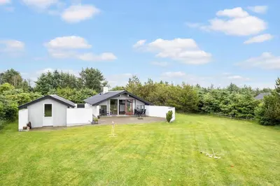 a house with a large lawn in front of it at BL1309-Blokhus-Quintusvej-22 in Blokhus