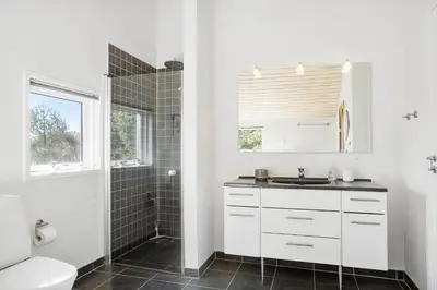 a white bathroom with a sink and a shower at BL512-Saltum-Trehoje-2 in Saltum