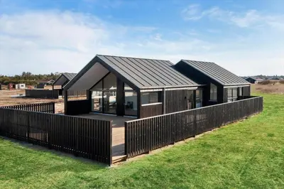 a modern house with a black roof at LK2144-Lokken-Kringelbaekvej-31 in Løkken