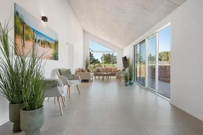 a living room with white walls and large windows at LK2146-Lokken-Redningsstien-2 in Løkken