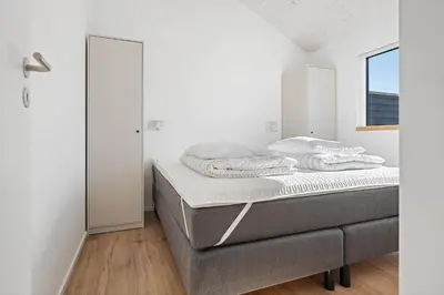 a bedroom with a bed and a window at LK2146-Lokken-Redningsstien-2 in Løkken