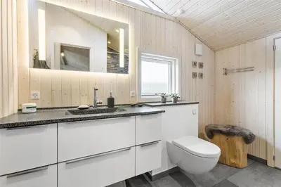 a white bathroom with a toilet and a sink at BL1092-Saltum-Doggerbanke-2 in Saltum