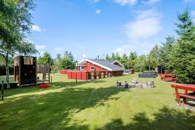 a park with a red barn and a playground at BL1092-Saltum-Doggerbanke-2 in Saltum