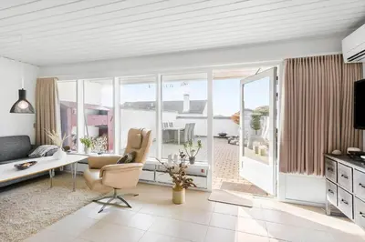a white living room with a table and chairs at BL1349-Pandrup-Rodhus-Klitvej-217 in Pandrup