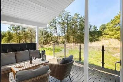 a patio with a couch and chairs on a deck at BL209-Saltum-Silkeborgvej-6 in Saltum