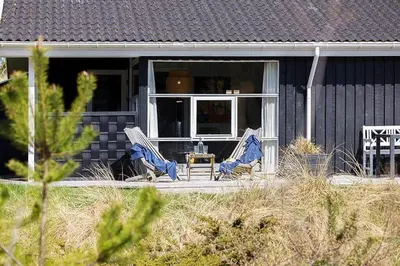 two chairs and a table on the porch of a house at BL209-Saltum-Silkeborgvej-6 in Saltum