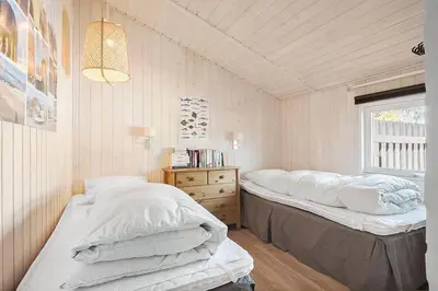 a bedroom with two beds and a window at BL209-Saltum-Silkeborgvej-6 in Saltum