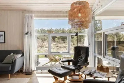 a living room with chairs and a large window at BL209-Saltum-Silkeborgvej-6 in Saltum