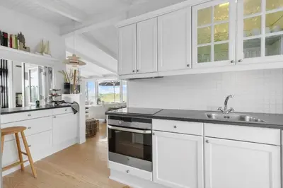 a white kitchen with a sink and a stove at LK2173-Lokken-Ruthsvej-9 in Løkken
