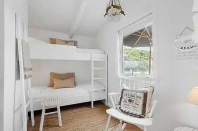 a room with two bunk beds and a chair at LK2173-Lokken-Ruthsvej-9 in Løkken