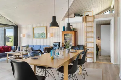 a dining room with a large wooden table and chairs at BL1511-Saltum-Tolhoj-21 in Saltum
