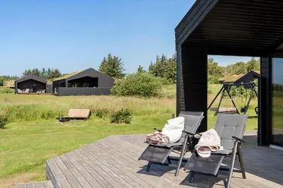 a couple of chairs sitting on a wooden deck at BL1511-Saltum-Tolhoj-21 in Saltum