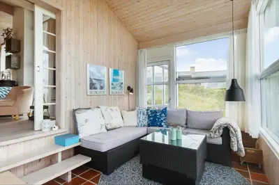 a living room with a couch and a table at BL1587-Blokhus-Karnoevej-1 in Blokhus