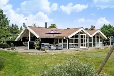 a house with a roof that has a patio at BL1438-Blokhus-Bloksbjerg-82 in Blokhus