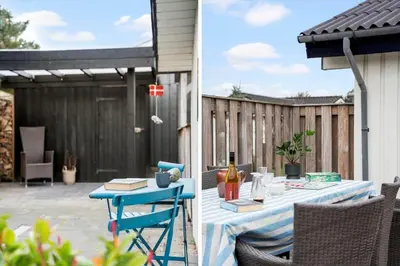 a patio with a table with a bottle of wine at BL1425-Blokhus-N-S-Larsensvej-6 in Blokhus