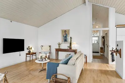 a living room with a couch and a tv at BL1425-Blokhus-N-S-Larsensvej-6 in Blokhus