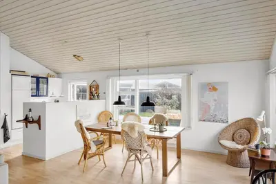 a kitchen and dining room with a table and chairs at BL1425-Blokhus-N-S-Larsensvej-6 in Blokhus