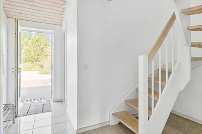 a staircase in a house with a white wall at BL1619-Blokhus-Klitheden-Nord-42 in Blokhus