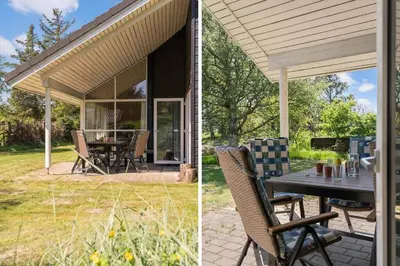 a screened in porch with a table and chairs at BL1382-Blokhus-Gyvelvej-20-A in Blokhus