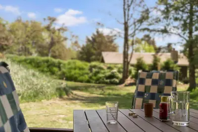 a wooden table with glasses on top of it at BL1382-Blokhus-Gyvelvej-20-A in Blokhus