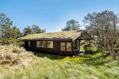a house with a grass roof on top of a hill at BL1225-Pandrup-Flaskehalsen-1 in Pandrup