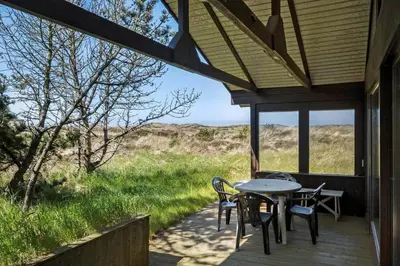 a patio with a table and chairs on a porch at BL1225-Pandrup-Flaskehalsen-1 in Pandrup