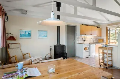 a living room with a table and a kitchen at BL1225-Pandrup-Flaskehalsen-1 in Pandrup