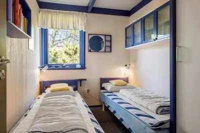 two beds in a room with a window at BL1225-Pandrup-Flaskehalsen-1 in Pandrup