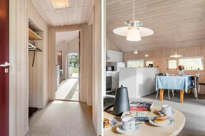 a kitchen and a dining room with a table in a house at BL1255-Pandrup-Rodhusparken-63 in Pandrup