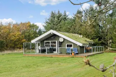 a house with a grass roof with a deck at BL1255-Pandrup-Rodhusparken-63 in Pandrup
