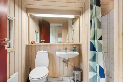 a bathroom with a toilet and a sink at BL1255-Pandrup-Rodhusparken-63 in Pandrup