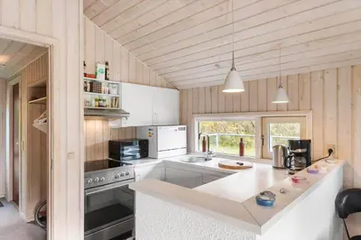 a kitchen with white appliances and a counter top at BL1255-Pandrup-Rodhusparken-63 in Pandrup