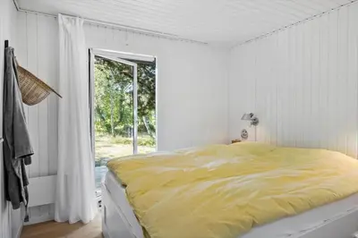 a white bedroom with a yellow bed and a window at BL1735-Pandrup-Rodhus-Skolevej-56 in Pandrup