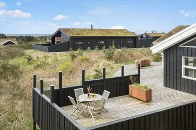 a wooden deck with a table and chairs on a house at BL189-Saltum-Bondagervej-71 in Saltum