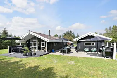 a small house with a patio and a grill at BL1566-Saltum-Lille-Fiskerbanke-3 in Saltum