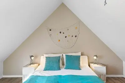 a bedroom with a bed with a hanging net at BL1582-Blokhus-Strandvejen-14-Lejl-11 in Blokhus