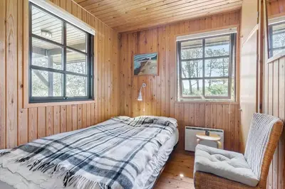 a bedroom with a bed and two windows at BL1570-Pandrup-Flaskehalsen-13-A in Pandrup