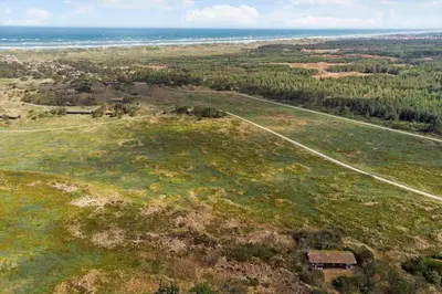 an aerial view of a field with a house and a road at BL1570-Pandrup-Flaskehalsen-13-A in Pandrup