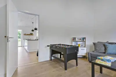 a living room with a ping pong table and a couch at BL1358-Saltum-Solmarken-5 in Saltum