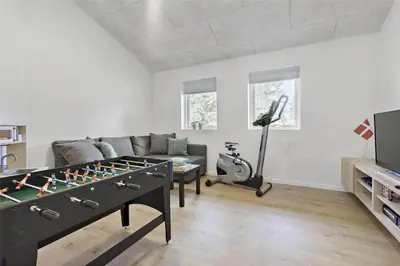 a living room with a couch and a foosball table at BL1358-Saltum-Solmarken-5 in Saltum