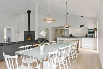 a dining room and kitchen with a table and chairs at BL1358-Saltum-Solmarken-5 in Saltum