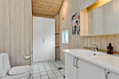 a bathroom with a toilet and a sink at BL247-Saltum-Haresvinget-9 in Saltum