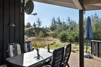 a table and chairs on the deck of a house at BL852-Saltum-Revlingevej-14 in Saltum