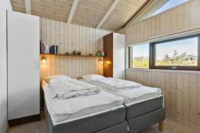 a bedroom with two beds in it with a window at BL852-Saltum-Revlingevej-14 in Saltum